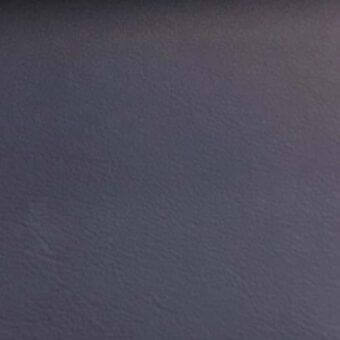 Leather rug, dark gray-purple, smooth texture, matte finish, tightly woven, uniform color, neutral gray background, diffused lighting.